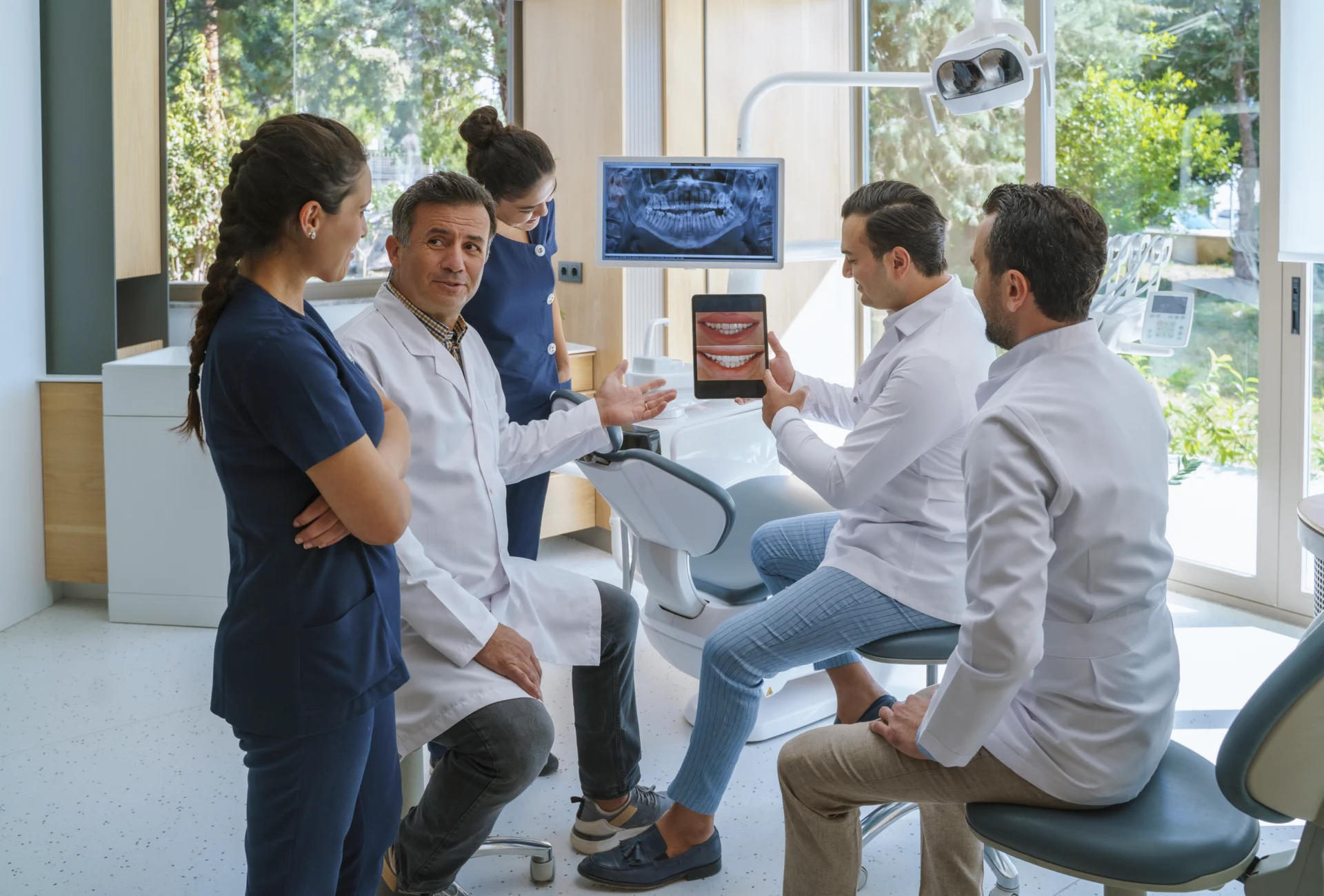 Dentists discussing dental procedure in office.