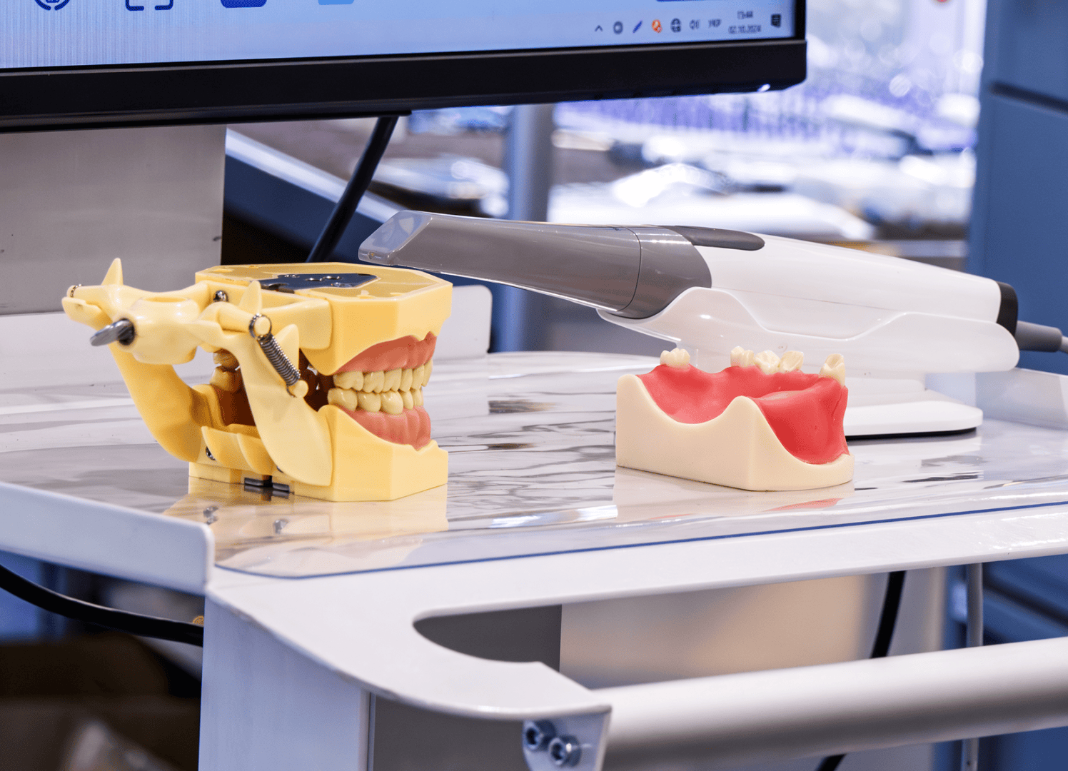 Dental models and scanner on table.