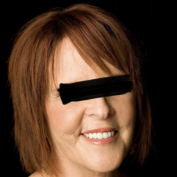 Smiling person with eyes obscured by black bar.
